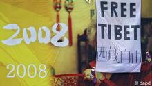 Pro Tibet activists unfurl a "Free Tibet" banner and Tibetan flags on top of a Beijing Olympics billboard, next to China Central Television headquarters in Beijing Friday, Aug. 15, 2008. Five foreigners were detained by police Friday when they unfurled the banner in the latest unauthorized protest during the games in the Chinese capital, an activist group said.(ddp images/AP Photo/Oded Balilty)