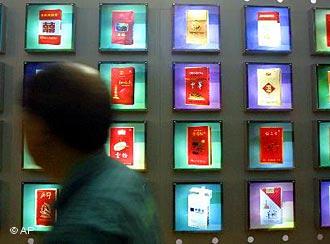 A screen displays a multitude packages of cigarettes made by Chinese companies during an exhibition in Beijing, China, Tuesday, May 21, 2002. Chinese companies are focusing on branding to compete against foreign brands that are gaining access as China relaxes its trade rules in accordance with the World Trade Organization. (AP Photo)