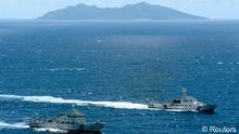 An aerial photo shows the Chinese marine surveillance ship Haijian No. 51 (L) cruising as a Japan Coast Guard ship Ishigaki sails near Uotsuri island, one of the disputed islands, called Senkaku in Japan and Diaoyu in China, in the East China Sea in this photo by Kyodo September 14, 2012. Six Chinese surveillance ships briefly entered waters near disputed islands claimed by Tokyo and Beijing on Friday, raising tensions between Asia's two biggest economies to their highest level since 2010. Mandatory credit.  REUTERS/Kyodo (JAPAN - Tags: POLITICS MARITIME MILITARY) FOR EDITORIAL USE ONLY. NOT FOR SALE FOR MARKETING OR ADVERTISING CAMPAIGNS. THIS IMAGE HAS BEEN SUPPLIED BY A THIRD PARTY. IT IS DISTRIBUTED, EXACTLY AS RECEIVED BY REUTERS, AS A SERVICE TO CLIENTS. MANDATORY CREDIT. JAPAN OUT. NO COMMERCIAL OR EDITORIAL SALES IN JAPAN. YES